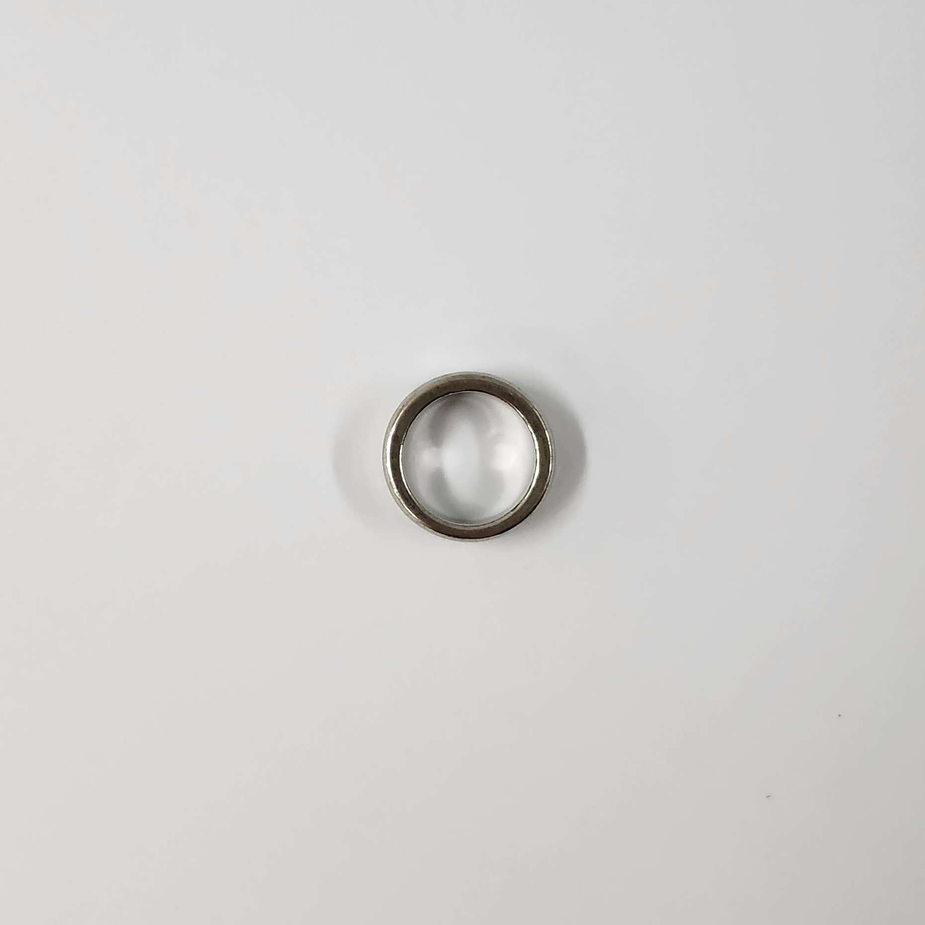 This is a silver ring that represents the shape of a torus.